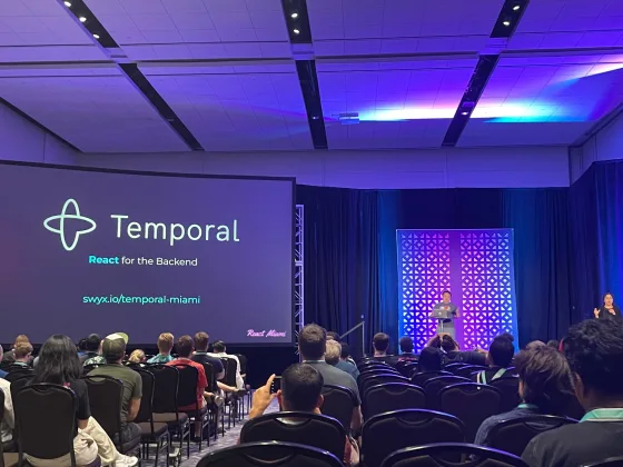 swyx presenting on stage at React Miami