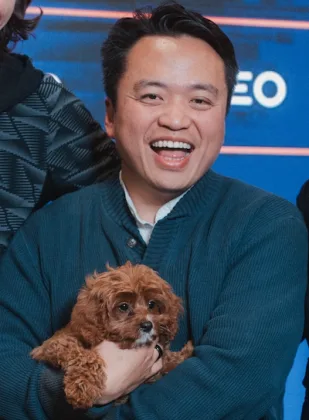 swyx holding a dog at Thursday Nights in AI